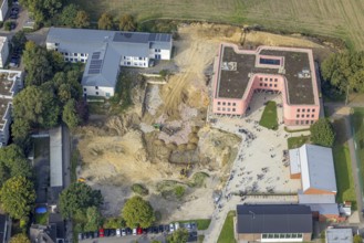 Aerial view, Pink building of the Reinoldi comprehensive school and construction site in the