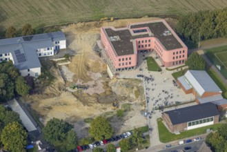 Aerial view, Pink building of the Reinoldi comprehensive school and construction site in the