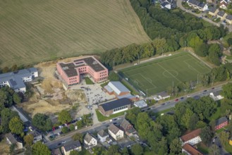 Aerial view, Pink building of the Reinoldi comprehensive school and construction site in the