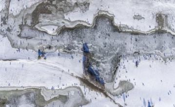 Aerial view, ice rink, ice skaters and pedestrians on frozen Rhine meadow in Lörrick near the