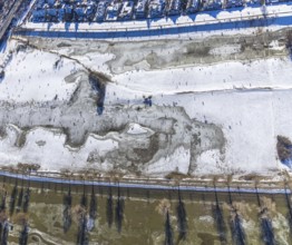 Aerial view, ice rink, ice skaters and pedestrians on frozen Rhine meadow in Lörrick near the
