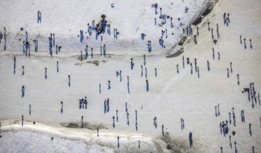 Aerial view, ice rink, ice skaters and pedestrians on frozen Rhine meadow in Lörrick near the