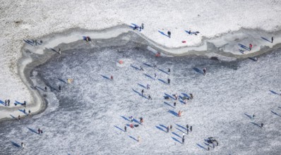 Aerial view, ice rink, ice skaters and pedestrians on frozen Rhine meadow in Lörrick near the