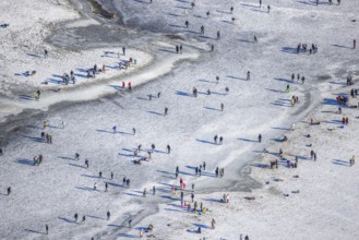 Aerial view, ice rink, ice skaters and pedestrians on frozen Rhine meadow in Lörrick near the