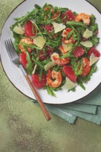 Fresh shrimp salad with arugula, grapefruit, and parmesan served in a bowl