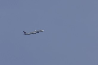 Airbus A350 jet passenger aircraft of Qater airlines flying in a blue sky, England, United Kingdom