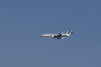 Executive business jet passenger aircraft in flight on approach to land, England, United Kingdom