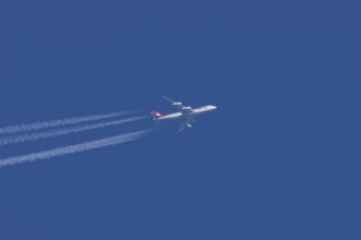 Boeing 747 Jumbo jet cargo aircraft of Cargolux airlines in flight in a blue sky with vapour trails