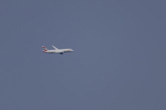 Boeing 787-9 Dreamliner jet passenger aircraft of British Airways airlines in flight in a blue sky,