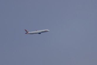 Boeing 787-9 Dreamliner jet passenger aircraft of British Airways airlines in flight in a blue sky,