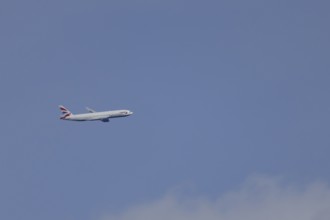 Boeing 787-9 Dreamliner jet passenger aircraft of British Airways airlines in flight in a blue sky,