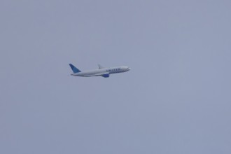 Jet passenger aircraft of United airways in flight in a blue sky, London, England, United Kingdom