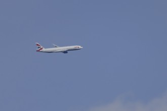 Boeing 787-9 Dreamliner jet passenger aircraft of British Airways airlines in flight in a blue sky,