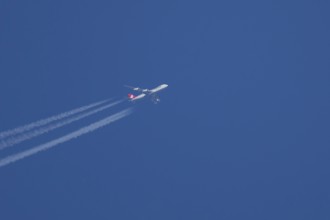Boeing 747 Jumbo jet cargo aircraft of Cargolux airlines in flight in a blue sky with vapour trails