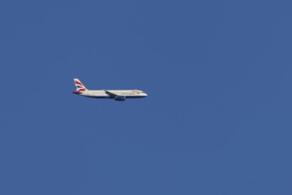 Airbus A320-232 jet passenger aircraft of British Airways airlines in flight in a blue sky, London,