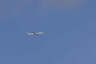 Jet passenger aircraft of ANA airways in flight in a blue sky, London, England, United Kingdom