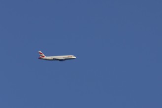 Airbus A320-232 jet passenger aircraft of British Airways airlines in flight in a blue sky, London,