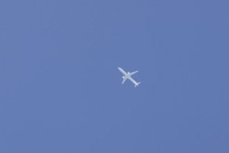 Airbus jet passenger aircraft flying in a blue sky, England, United Kingdom