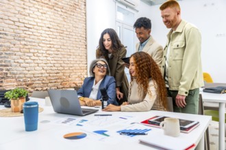 Diverse business professionals sharing ideas and laughing together during a collaborative podcast