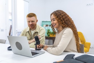 Engaging male and female content creators collaborating on a podcast, recording audio for digital