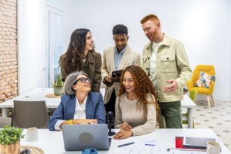 Diverse business team collaborating and brainstorming ideas during a casual work meeting in a