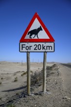 Sign warning of brown hyenas or beach wolves (Parahyaena brunnea), near Lüderitz, Karas Region,