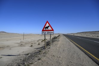 Sign warning of brown hyenas or beach wolves (Parahyaena brunnea), near Lüderitz, Karas Region,