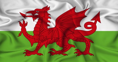 Realistic Wales flag waving. Close up of flag of Wales with cloth texture