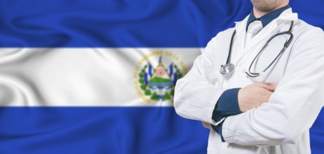 El Salvador healthcare concept. Male doctor on El Salvador flag. Doctor with crossed arms on El
