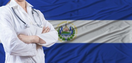 Doctor with crossed arms on El Salvador flag. El Salvador health and care concept. Female doctor on
