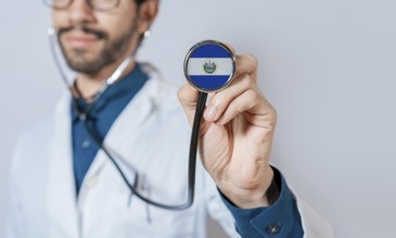 Doctor holding stethoscope with El Salvador flag. El Salvador health and care concept. El Salvador
