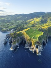 Cape Furado, Rocky Cliffs, Hills, Green Lush Fields, Pasturelands and Atlantic Ocean at Sunrise.