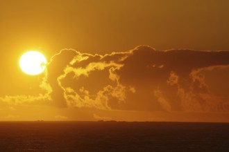 Bright sunset on the horizon with dramatic clouds, Orkney Islands, Scotland, Great Britain