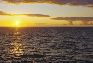 Sunset over the sea with yellow reflections on the waves, Orkney Islands, Scotland, Great Britain