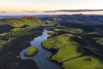 Moss-covered landscape with mountains and river in the Icelandic Highlands, Iceland