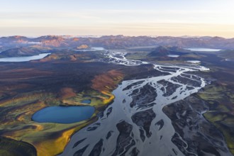 Landscape with turquoise crater lake, river and mountains, Icelandic Highlands, Iceland