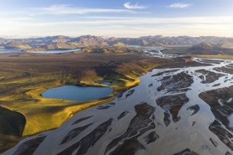 Landscape with turquoise crater lake, river and mountains, Icelandic Highlands, Iceland