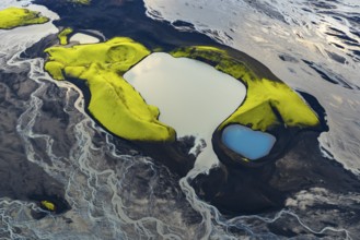 Turquoise-coloured crater lake with moss-covered crater rims in the Icelandic highlands, surrounded