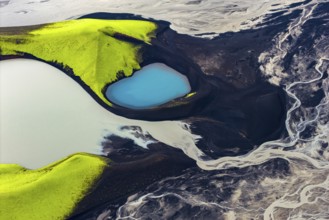 Turquoise-coloured crater lake with moss-covered crater rims in the Icelandic highlands, surrounded