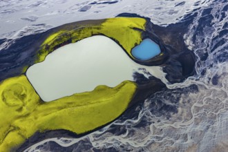 Turquoise-coloured crater lake with moss-covered crater rims in the Icelandic highlands, surrounded