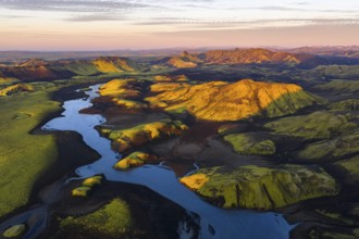 Mossy landscape with river and mountains at sunrise, Icelandic Highlands, Iceland