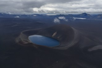 Blue crater lake in black sand desert, Icelandic Highlands, Iceland