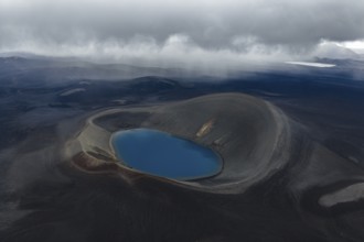 Blue crater lake in black sand desert, Icelandic Highlands, Iceland