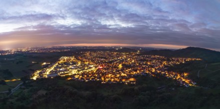 Panoramic view of an illuminated town under a cloudy evening sky, Korb im Remstal,