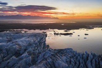 Glacier with Fjallsarlon glacier lagoon at sunrise, Vatnajökull National Park, South Iceland,