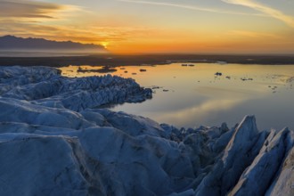 Glacier with Fjallsarlon glacier lagoon at sunrise, Vatnajökull National Park, South Iceland,