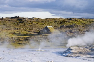 Steaming springs and traditional house at the Hveravellir geothermal area, Icelandic Highlands,
