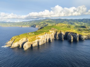 Cape Cintrao, Cliffs, Green Lush Hills, Fields, Pasturelands and Atlantic Ocean on Sunny Evening.