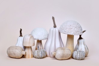Decorative pumpkin, mushroom and acorn ornaments on beige background. Boho autumn composition