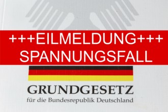 Tension case Symbolic image: The lettering EILMELDUNG SPANNUNGSFALL, with the German Basic Law
